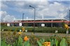 A Shot of The Transit Center with Some Nearby Flowers in Bloom